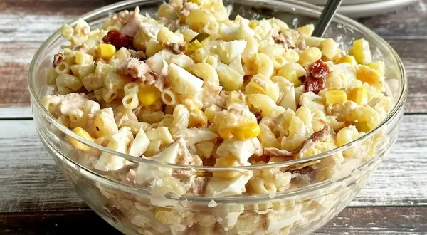 Pyszna sałatka z tuńczykiem i makaronem, jajkiem i kukurydzą w szklanej misie. Idealna na szybki obiad.