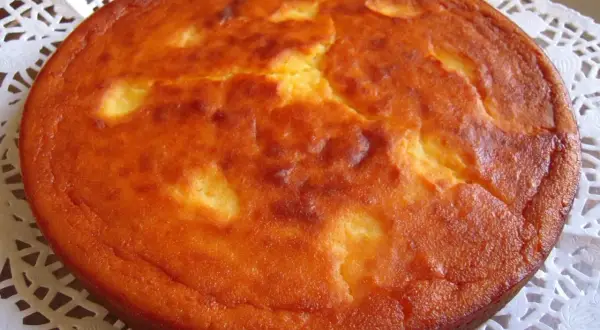 Migliaccio napoletano ricetta della nonna: una torta dorata e soffice, con la crosticina leggermente screpolata, pronta per essere gustata.