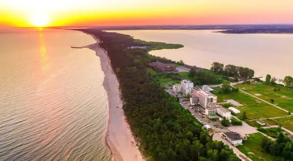 Zachód słońca nad morzem, plaża i hotele w Mielnie. Warto sprawdzić blue marine mielno opinie przed wyjazdem.