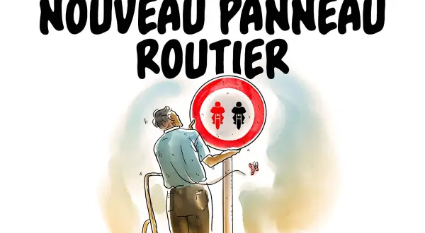 Un homme installe un nouveau panneau routier interdisant les motocyclettes et cyclomoteurs.