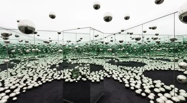 An infinity room filled with mirrored spheres, creating a dazzling, endless reflection at the Rubell Museum Miami.