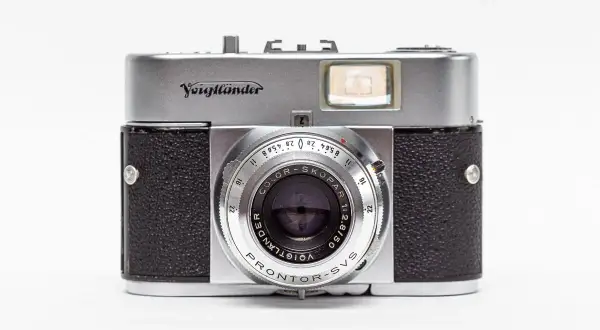 A vintage silver and black Voigtländer camera with a prominent lens and viewfinder.