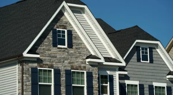 Modern homes with dark asphalt shingles, showcasing their durability and aesthetic appeal.