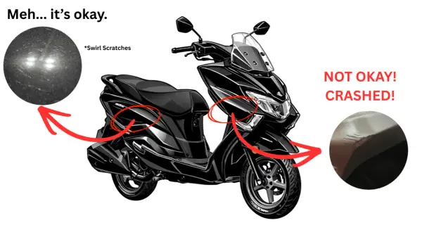 Czarny skuter z widocznymi uszkodzeniami. Sprawdzenie motocykla przed kupnem ujawnia drobne rysy i poważne pęknięcia po upadku.