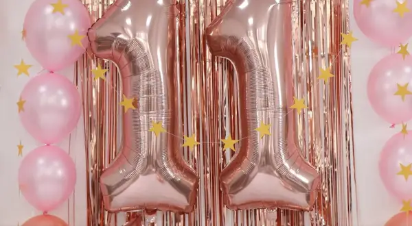 Globos rosas y dorados con estrellas, formando el número 11. ¡Ideas para celebrar tu cumpleaños!