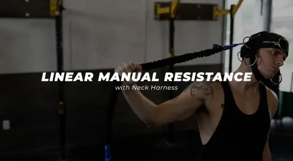 Man using a neck harness for linear manual resistance training, working neck muscles.