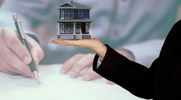 Mano che firma un accordo per vendere casa con genitore in casa di riposo.