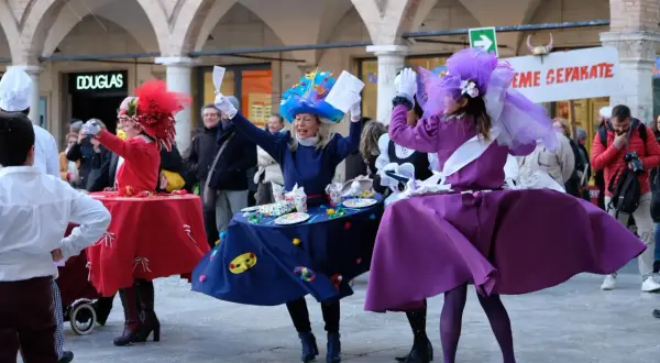 Persone in costume colorato danzano durante il carnevale di Ascoli.