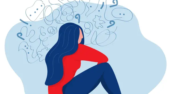 En person sitter med huvudet i händerna, omgiven av kaos. Kan en psykolog sjukskriva? Ja, vid psykisk ohälsa.