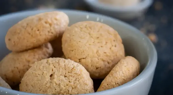 Kleine, goldbraune Amarettini in einer Schale, bereit zum Genießen. Ein einfaches amarettini rezept für süße Momente.