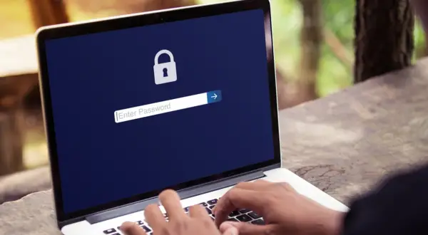 Laptop z ikoną kłódki i polem do wpisania hasła.