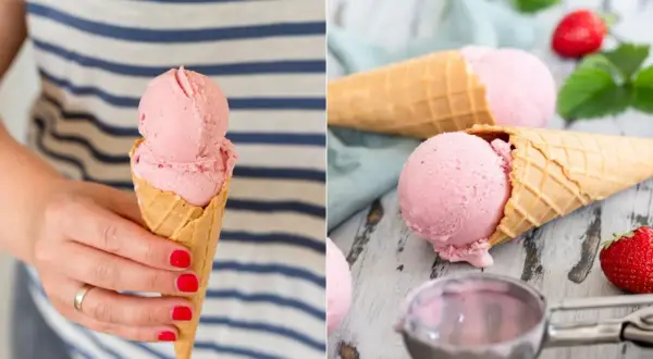 Zwei Eiswaffeln mit cremigem, rosa Erdbeereis vegan. Eine Hand hält eine Waffel, daneben liegen frische Erdbeeren.