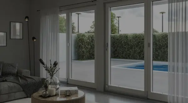 Soggiorno moderno con grandi vetrate che si affacciano su una piscina. Ideale per chi cerca un buon isolamento acustico finestre fai da te.