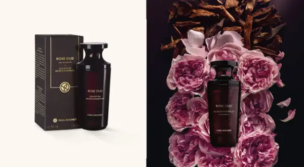 Flakon perfum Rose Oud Yves Rocher otoczony płatkami róż i drewnem oud.