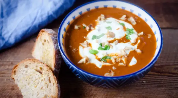 Aksamitna pasta z bakłażana, udekorowana śmietaną i orzechami, podana z chrupiącym pieczywem.