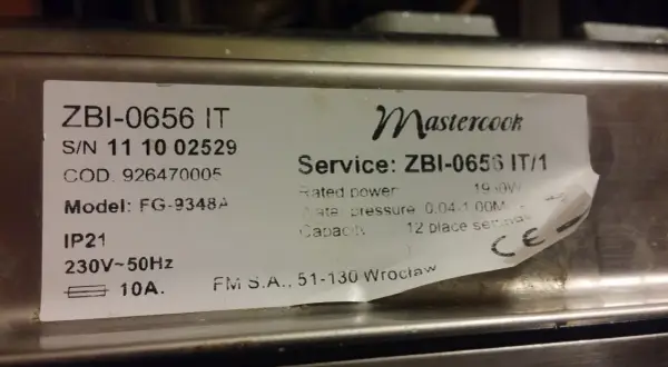Naklejka z danymi technicznymi kuchenki Mastercook ZBI-0656 IT. Znajdziesz tu m.in. numer seryjny, model FG-9348A, moc 1950W, ciśnienie wody 0.04-1.00M, pojemność 12 kompletów.