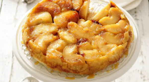 Apetyczna tarta tatin z karmelizowanymi jabłkami, podana na paterze.