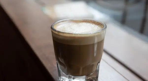 En kaffedröm: en perfekt balanserad macchiato vs cortado, med len mjölk och stark espresso.