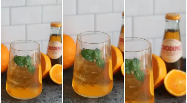 Erfrischender Crodino Spritz mit Eis, Minze und Orangenstücken. Perfekt für einen sonnigen Nachmittag.