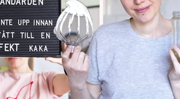En person håller upp en skylt med texten "Ge inte upp innan du fått till en perfekt kaka". Bredvid syns en visp med grädde och en tom burk, redo för en vegansk fika.