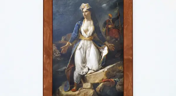 Kobieta w greckim stroju na tle ruin Missolungi, z żołnierzem w tle. Symbol wolności i walki o niepodległość.