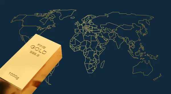 Sztabka złota na tle mapy świata. Obraz symbolizuje globalne zasoby złota i jego znaczenie w światowej gospodarce.