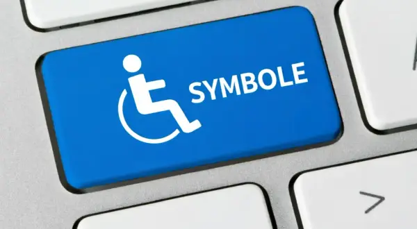 Niebieski klawisz z symbolem osoby na wózku inwalidzkim i napisem "SYMBOLE". Co oznacza symbol n 12f?