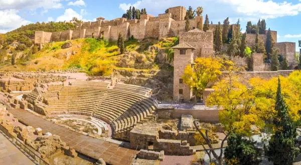 Vestiges d'un théâtre romain et de l'Alcazaba, un site historique à visiter à Malaga, sous un ciel bleu éclatant.