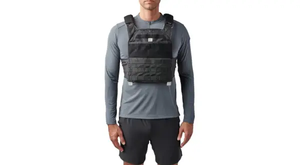 Mann trägt eine 5.11 Gewichtsweste über einem grauen Langarmshirt und schwarzen Shorts.