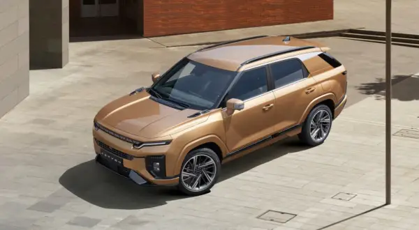 Złoty SUV z rodziny koreańskie marki aut, z nowoczesnym designem i eleganckimi felgami, zaparkowany na placu.