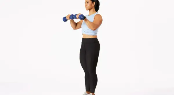 Woman performing dumbbell bicep curls, a key exercise for how to get stronger arms for a girl.