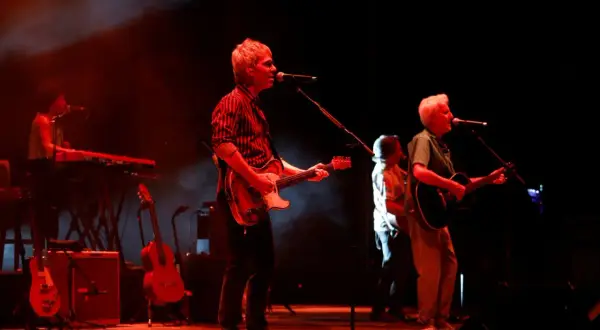 Kiko Veneno y Martirio en concierto, con luces rojas y humo. Kiko toca la guitarra eléctrica, Martirio la acústica.