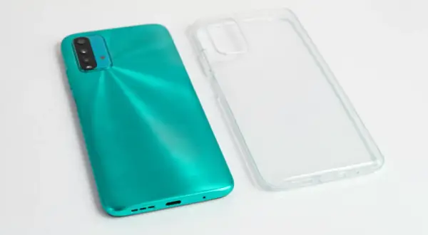 Turkusowy telefon i przezroczyste etui obok. Zastanawiasz się, czym umyć etui od telefonu, by znów wyglądało jak nowe?