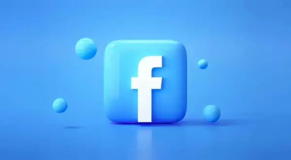 Błękitny, błyszczący kwadrat z białym "f" – tak wygląda faktura z Facebooka. Wokół unoszą się małe, niebieskie kuleczki.