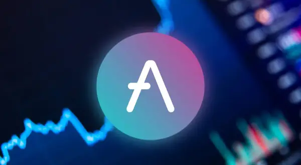 Das AAVE Coin-Logo leuchtet vor einem unscharfen Hintergrund mit einem blauen Diagramm, das den Markt widerspiegelt.