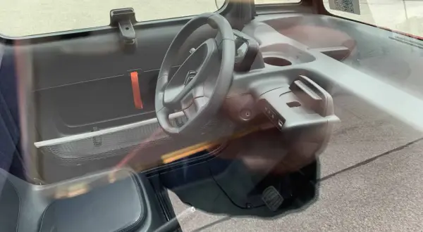 Wnętrze Citroen Ami, z kierownicą i siedzeniem. Sprawdź atrakcyjną citroen ami cena!