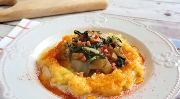 Puré de patatas con un sofrito de acelgas y trocitos de jamón. Una deliciosa receta con acelgas, espolvoreada con pimentón.