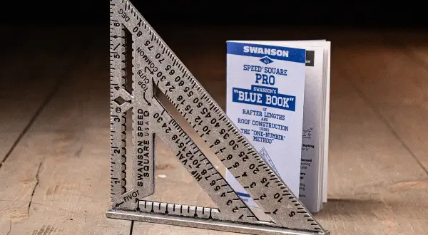 A Swanson Speed Square and its "Blue Book" guide, showing how to use a speed square for roof construction.