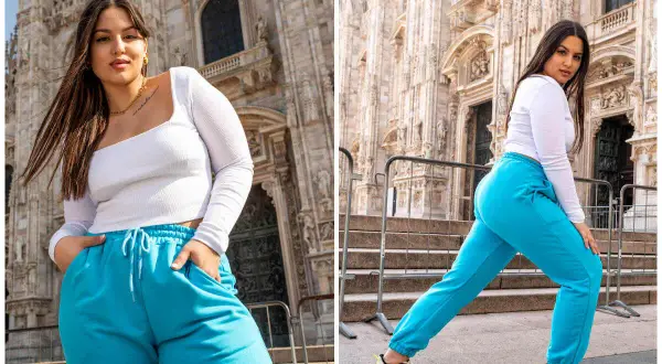 Kobieta plus size, co to znaczy? Pewność siebie w turkusowych dresach przed monumentalną budowlą.