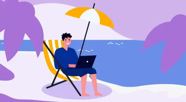 Mężczyzna pracuje na laptopie na plaży pod parasolem. Idealne miejsce na urlop, od kiedy 35 dni urlopu to norma.