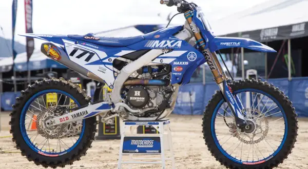 Una moto Yamaha de motocross azul y blanca, lista para la acción. El número 171 y el logo de MXA Motocross Action destacan.