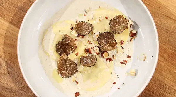Ravioli med lyxig ravioli fyllning, toppad med tryffel och hasselnötter i krämig sås.