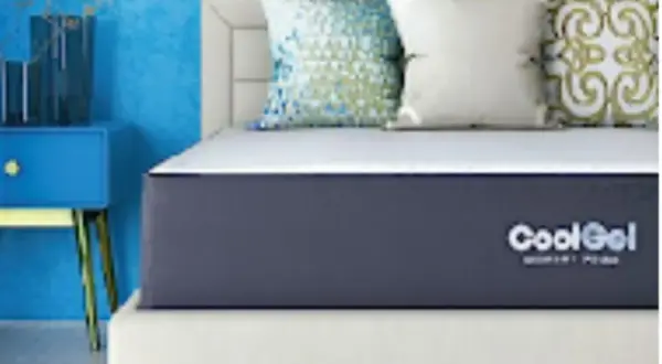 A CoolGel memory foam mattress on a bed with decorative pillows. Is memory foam safe? Yes, this mattress offers safe, comfortable sleep.