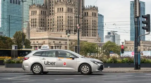 Srebrny samochód Uber na tle warszawskich wieżowców. Czy to Twój pierwszy raz z Uberem?