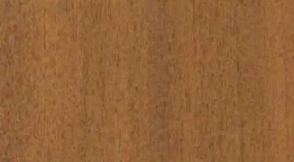 Textura de madera de mansonia, con vetas finas y un tono marrón rojizo cálido.