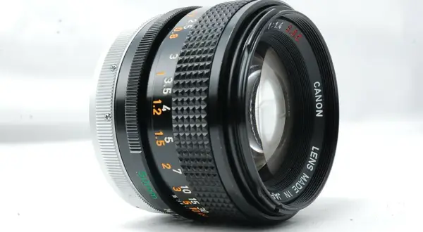 A Canon 50mm f/1.4 SSC lens, a contender for the best Canon FD lens, showcasing its aperture and focus rings.