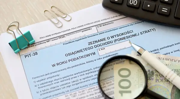 Formularz PIT-38, kalkulator, lupa powiększająca 100 zł. Czas na rozliczenie dochodów, czy to hossa, czy bessa, trzeba wypełnić zeznanie.