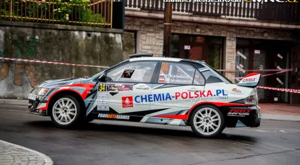 Rally car Mitsubishi Lancer Evo 9 z numerem 34 i logiem "Chemia-Polska.pl" na trasie wyścigu.