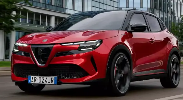 Czerwony SUV Alfa Romeo na drodze, jeden z najlepszych SUVów, z nowoczesnym designem i sportowym charakterem.