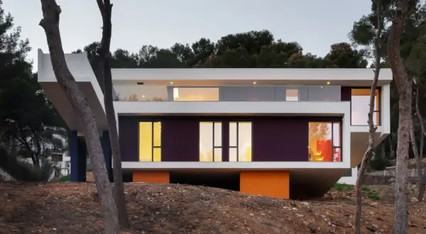 Casa moderna con voladizos y grandes ventanales, ideal para suelo rústico.